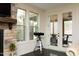 Sitting area with a stone fireplace, windows, and access to an outdoor seating area at 156 Stoney Creek Way, Chapel Hill, NC 27517