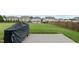 Large backyard with lush green grass, surrounded by fences, with a patio and grill area for outdoor entertaining at 190 Hickory Run Ln, Franklinton, NC 27525
