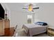 Well-lit bedroom with ceiling fan, desk, and comfortable bed, bathed in natural light at 190 Hickory Run Ln, Franklinton, NC 27525