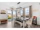 Sunlit dining area with sliding glass door, a rustic table with bench, flowing to the kitchen area at 190 Hickory Run Ln, Franklinton, NC 27525