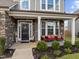 Inviting front porch with stone pillars, comfortable seating, and lush landscaping at 190 Hickory Run Ln, Franklinton, NC 27525