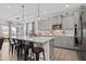 Beautiful kitchen boasts gray cabinets, stainless steel appliances, an expansive island with barstool seating, and pendant lights at 190 Hickory Run Ln, Franklinton, NC 27525