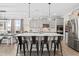Open-concept kitchen features a large island with barstool seating, stainless appliances, and elegant pendant lights at 190 Hickory Run Ln, Franklinton, NC 27525