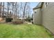 Green backyard featuring a lush lawn and a beautiful garden area with a retaining wall at 200 Parkbranch Ln, Cary, NC 27519