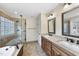 Spacious bathroom with dual sinks, a soaking tub, and a glass-enclosed shower at 200 Parkbranch Ln, Cary, NC 27519