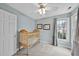 Light blue bedroom with a ceiling fan, closet and exterior views from the window at 200 Parkbranch Ln, Cary, NC 27519
