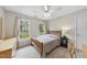 Cozy bedroom featuring two windows, a ceiling fan and carpeted floors at 200 Parkbranch Ln, Cary, NC 27519