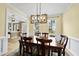 Inviting dining room with hardwood floors, elegant lighting, and views to the front yard at 200 Parkbranch Ln, Cary, NC 27519