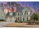 Charming two-story home with a two-car garage, black shutters, and manicured landscaping at sunset at 200 Parkbranch Ln, Cary, NC 27519