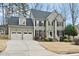 Charming two-story home with a two-car garage, black shutters, and manicured landscaping at 200 Parkbranch Ln, Cary, NC 27519