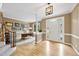 Inviting foyer with hardwood floors, staircase, and office featuring a wood desk and front door at 200 Parkbranch Ln, Cary, NC 27519