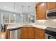 Close-up of eat-in kitchen details including stainless appliances, custom cabinets, granite counters and pendant lights at 200 Parkbranch Ln, Cary, NC 27519