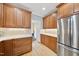 Kitchen details including stainless refrigerator, custom cabinets, granite counters, ceramic tile backsplash and hardwood floors at 200 Parkbranch Ln, Cary, NC 27519