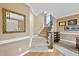 Inviting foyer with carpeted stairs leading to the upper level and a decorative mirror at 200 Parkbranch Ln, Cary, NC 27519