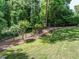A lush backyard with mature trees offers a serene and private outdoor space at 2001 Manuel St, Raleigh, NC 27612