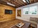 Basement featuring a lounge area with a tv and neutral sofa, and a wood accent wall at 2001 Manuel St, Raleigh, NC 27612