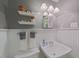 Bathroom showcases white walls, a pedestal sink, and shelving that offers plenty of space to store bathroom necessities at 2001 Manuel St, Raleigh, NC 27612
