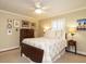 Spacious bedroom features a ceiling fan, a double bed, and warm lighting at 2001 Manuel St, Raleigh, NC 27612