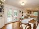 Dining room features wood floors, white wainscoting, and French doors to a deck at 2001 Manuel St, Raleigh, NC 27612