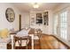 Cozy dining room featuring built-in shelves, a wooden table, and access to the outdoors at 2001 Manuel St, Raleigh, NC 27612
