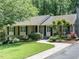 Charming exterior with brick walkway, lush landscaping, and inviting facade on a sunny day at 2001 Manuel St, Raleigh, NC 27612