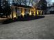 A brick home at dusk features manicured landscaping and a large front yard at 2001 Manuel St, Raleigh, NC 27612