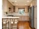 Bright kitchen with stainless steel appliances, light wood cabinets and barstool seating at 2001 Manuel St, Raleigh, NC 27612