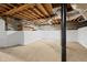 Unfinished basement featuring a concrete floor and exposed wooden ceiling for customizable potential at 203 Lexington Rd, Chapel Hill, NC 27516