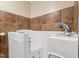 Accessible bathroom featuring a walk-in tub with jets, neutral-toned tiles, and a showerhead at 203 Lexington Rd, Chapel Hill, NC 27516