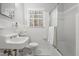 White tiled bathroom with window over toilet and tub/shower combo at 203 Lexington Rd, Chapel Hill, NC 27516