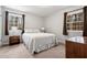 Bedroom featuring neutral walls, carpet, and two windows with brown curtains at 203 Lexington Rd, Chapel Hill, NC 27516
