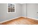 Unfurnished bedroom with hardwood floors and a bright window at 203 Lexington Rd, Chapel Hill, NC 27516