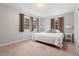 Bedroom featuring neutral walls, carpet, and two windows with brown curtains at 203 Lexington Rd, Chapel Hill, NC 27516