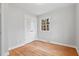 Unfurnished bedroom with hardwood floors, a window, and a double closet at 203 Lexington Rd, Chapel Hill, NC 27516