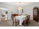 Bright dining room with a table for six beneath a modern light fixture at 203 Lexington Rd, Chapel Hill, NC 27516
