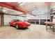 Garage featuring a red Corvette, a workbench, and ample space for car storage and projects at 203 Lexington Rd, Chapel Hill, NC 27516