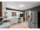 Bright kitchen with white cabinets, stainless steel appliances, dark green walls, and a window over the sink at 203 Lexington Rd, Chapel Hill, NC 27516