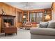 Inviting living room featuring a fireplace, wood paneling, and ample seating area at 203 Lexington Rd, Chapel Hill, NC 27516