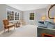 Inviting living room featuring comfortable seating, a cozy carpet, and large windows with views of the surrounding greenery at 203 Lexington Rd, Chapel Hill, NC 27516