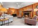 Cozy living room with wood paneled walls, brick fireplace, and comfortable seating at 203 Lexington Rd, Chapel Hill, NC 27516