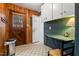 Mud room featuring wood paneled walls, a vintage door, and tiled flooring at 203 Lexington Rd, Chapel Hill, NC 27516