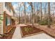 Spacious side yard with a concrete path, garden beds, and mature trees at 203 Lexington Rd, Chapel Hill, NC 27516