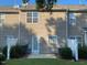 Back of townhome that shows the door, patio, and landscaping around the patio at 21 Suncrest Ct, Durham, NC 27703