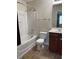Bright bathroom featuring a white vanity, toilet, and a shower-tub combination with tiled flooring at 21 Suncrest Ct, Durham, NC 27703