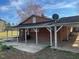 Brick house with covered parking and backyard patio area at 2117 George Winston Rd, Oxford, NC 27565