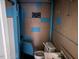 Bathroom with toilet, sink, and blue-painted accent wall highlighting the bath rules at 2117 George Winston Rd, Oxford, NC 27565