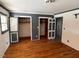 A bedroom with hardwood floors, white walls, and two closets with gray trim at 2117 George Winston Rd, Oxford, NC 27565