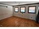 Bedroom featuring hardwood floors, three windows, and neutral wall color at 2117 George Winston Rd, Oxford, NC 27565