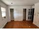 Bedroom with hardwood flooring, two closets with louvered doors, and white walls at 2117 George Winston Rd, Oxford, NC 27565