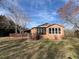 Ranch-style home featuring a brick exterior with large windows and an enclosed porch at 2117 George Winston Rd, Oxford, NC 27565